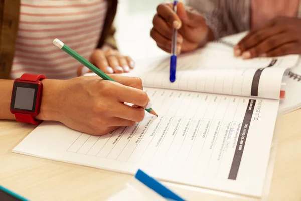 Two students completing task in their copybook — Stock Photo, Image