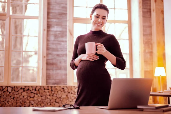 Pleased businesswoman going to drink hot tea — Stock Photo, Image