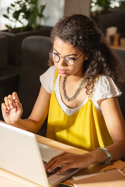 Sérieux jeune femme regardant l'écran de l'ordinateur portable — Photo