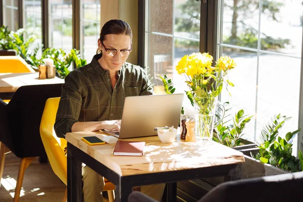 Handsome long haired man focusing on his work