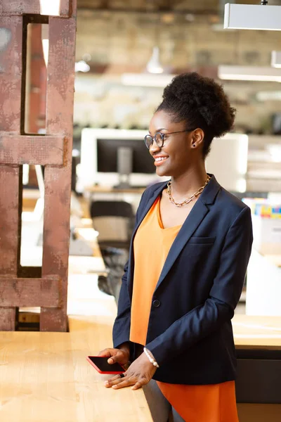 Beaming ontwerper staande in de buurt van venster en gevoel gelukkig — Stockfoto