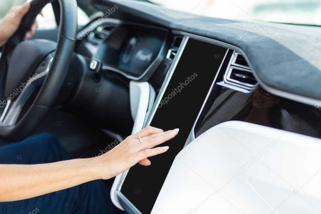Woman driving car in the morning using navigator