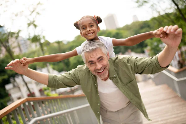 Beaming beautiful daughter feeling happy with daddy — Stock Photo, Image