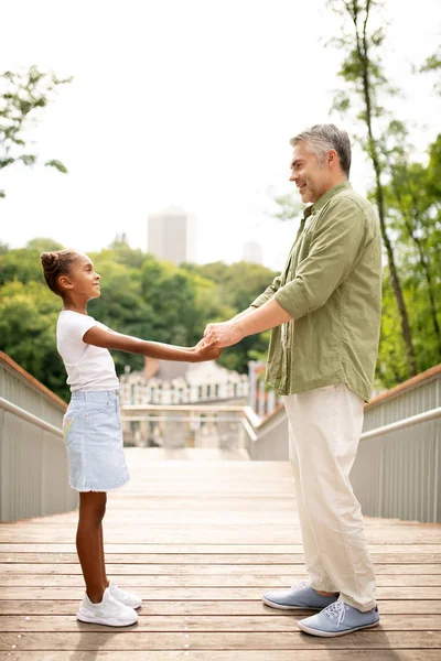 Mature man meeting his adopted girl in the park — Stock Photo, Image