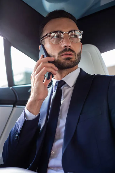 Stylish businessman wearing suit and tie calling his wife — Stock Photo, Image