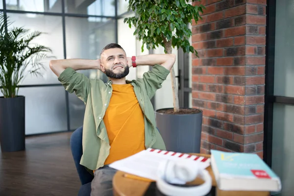 Bearded man feeling satisfied after studying at the weekend — Stock Photo, Image