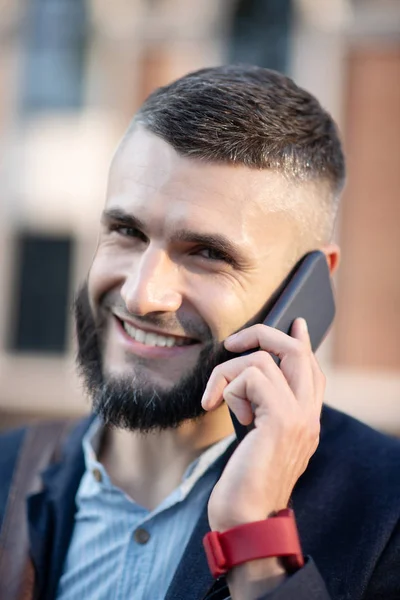 Businessman calling his girlfriend after finishing work