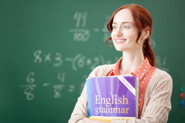 Red-haired English teacher feeling thoughtful before lesson clipart