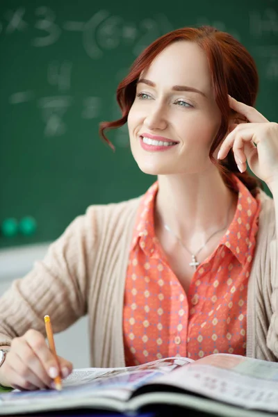 Smiling teacher feeling good while working at school — Stock Photo, Image