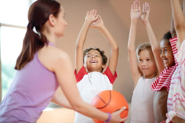 Kinderen juichen voordat ze samen basketballen — Stockfoto