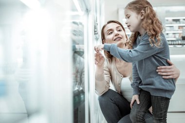Sevgi dolu bir anne bir vitamin seçimi ile kızı yardımcı.