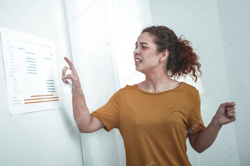 Curly red-haired woman studying allergens for her body