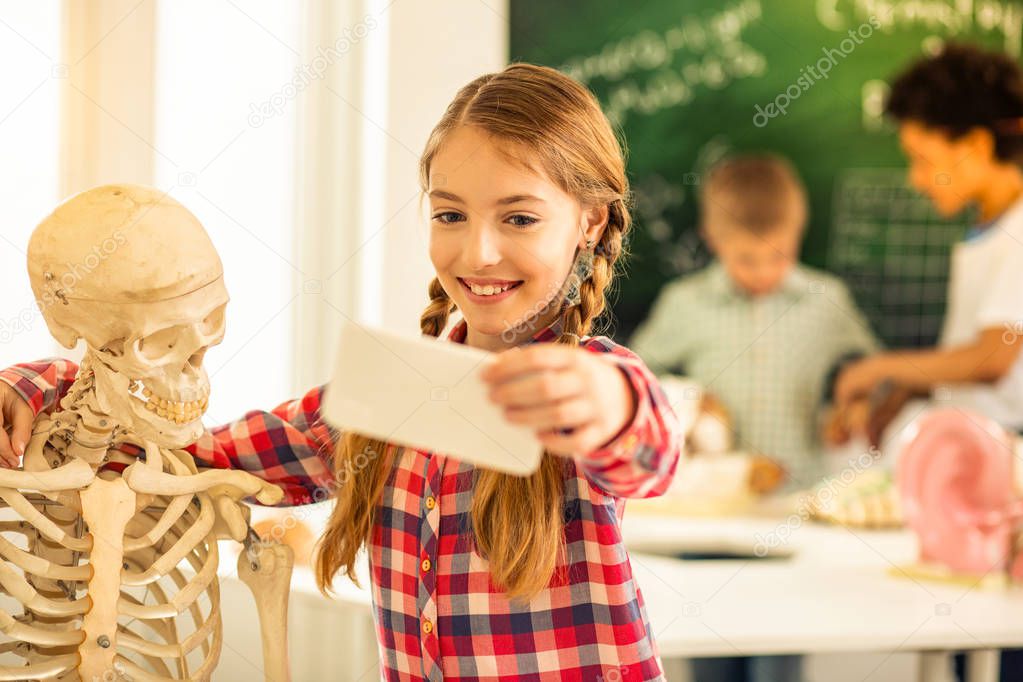 Friendly girl embracing her new artificial skeleton