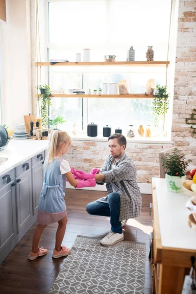 Daddy and his cute daughter preparing for cleaning