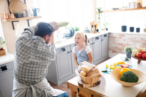 Padre e hija riendo y bromeando mientras cocinan —  Fotos de Stock