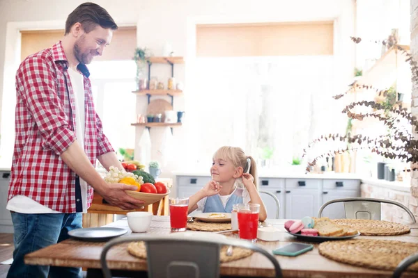 Loving daddy bringing some vegetables for breakfast — ストック写真