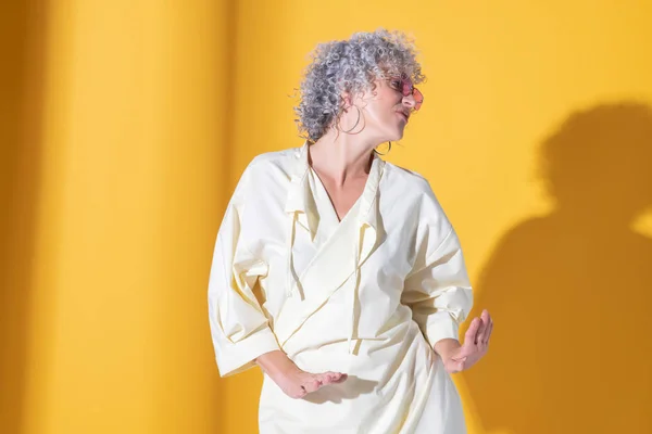 Curly grey-haired woman dancing while feeling amazing — 스톡 사진