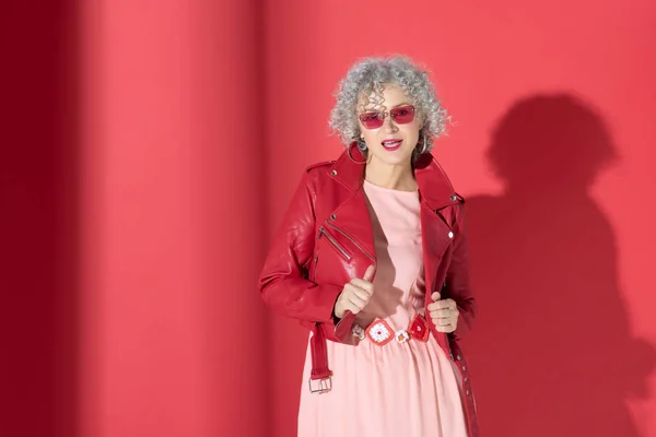 Stylish mature woman wearing red leather jacket — Stockfoto