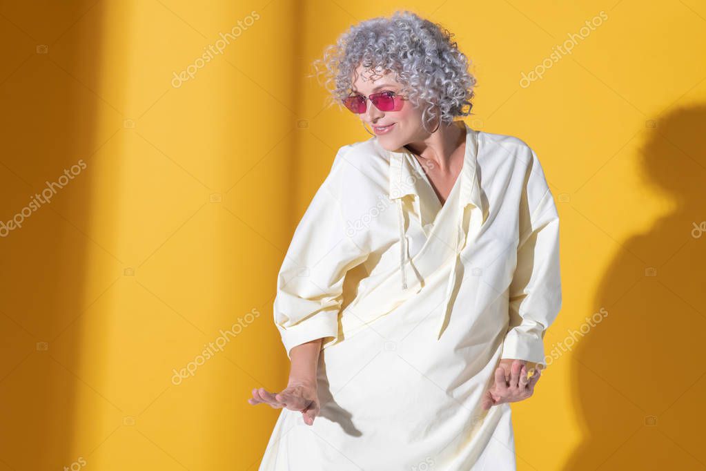 Mature woman wearing long dress moving and dancing