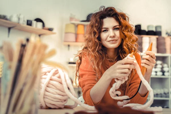 Positive delighted long-haired female demonstrating her hobby — 스톡 사진