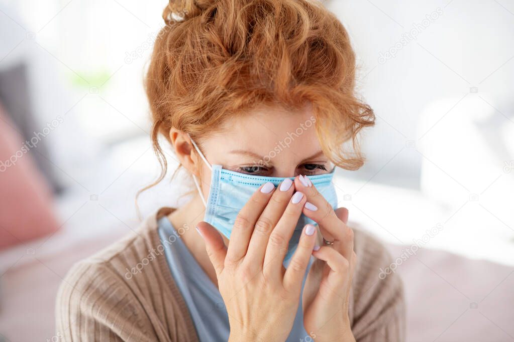 Woman wearing mask in order not to communicate disease to relatives
