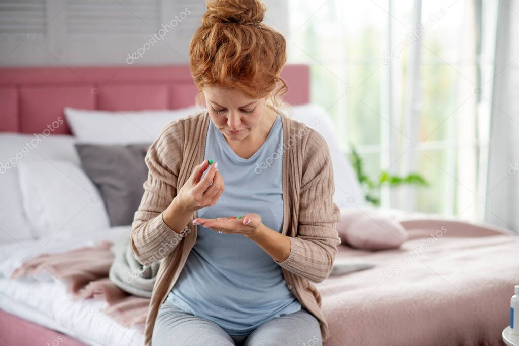 Woman having flu taking medicine after doctor prescription