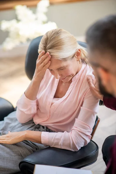 Blonde mid-aged woman suffering from strong headache — Stock Photo, Image