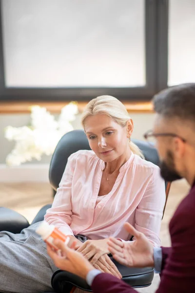 Bearded young psychologist recommending sleeping pills to the patient