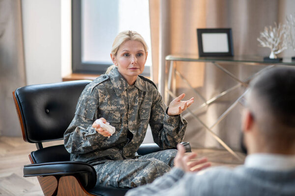 Blonde military mid-aged woman attending psychologist regularly