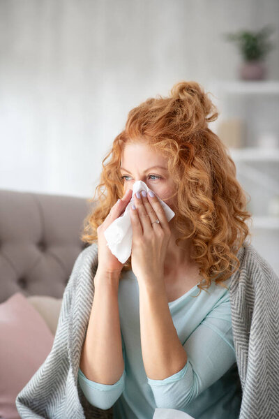 Woman having sneeze while suffering from epidemic