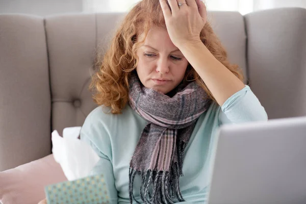 Curly woman wearing scarf watching movie and sneezing all day — Stock Photo, Image