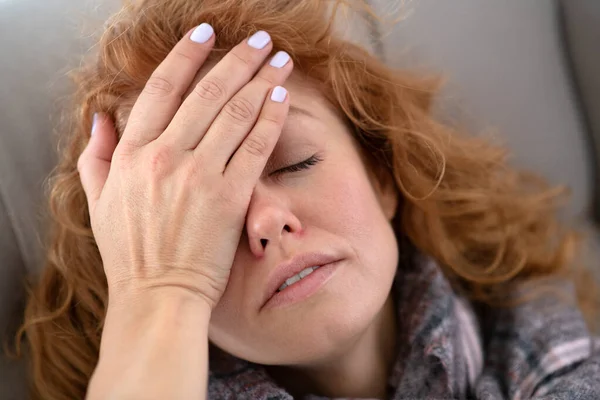 Red-haired pretty young woman having terrible headache — Stock Photo, Image