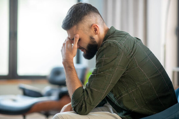 Man sitting near window and waiting for his psychoanalyst