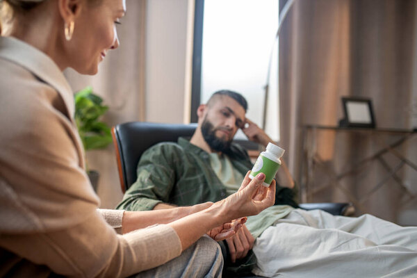 Close up of psychologist giving sleeping pills to patient