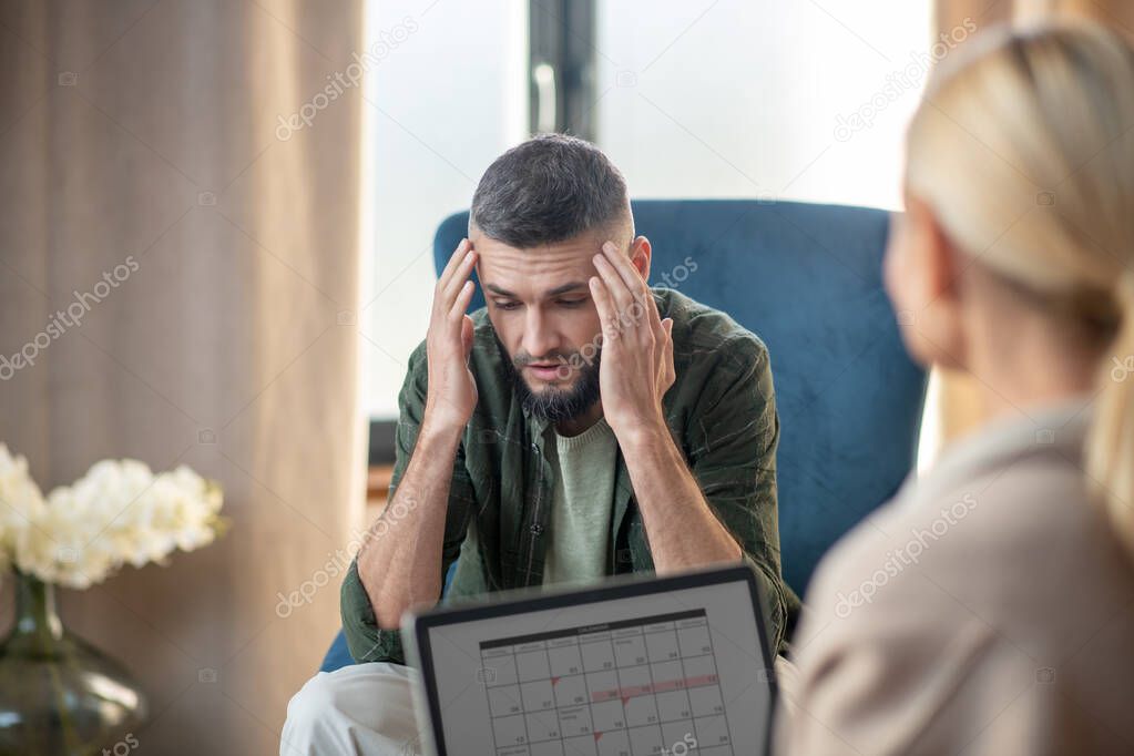 Bearded young man sharing problems with psychoanalyst