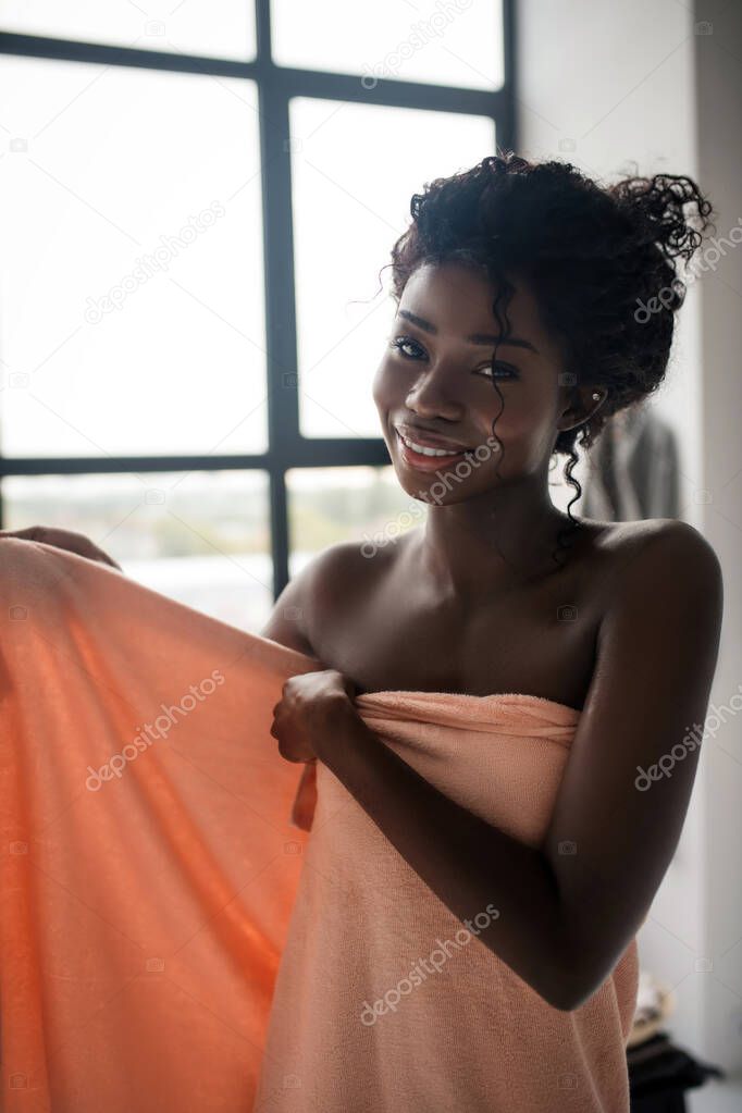 Woman smiling while feeling energetic after having bath