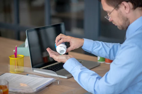 Close up of office worker taking pills while having sore throat — 图库照片