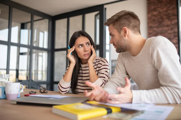 Husband and wife feeling suspicious while filling tax declaration — Stock Photo, Image