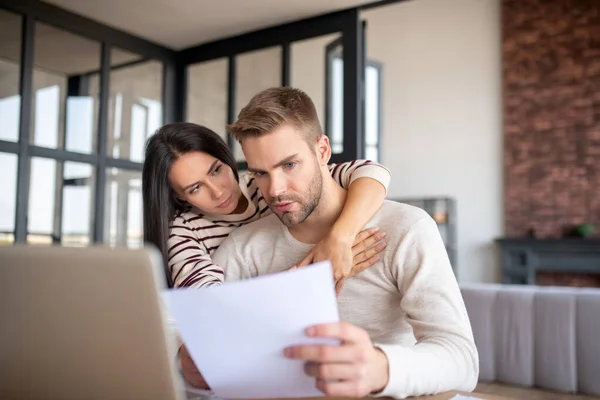 Handsome blue-eyed husband having too much job