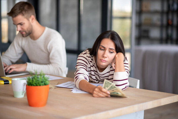 Wife feeling upset after family budget planning with husband