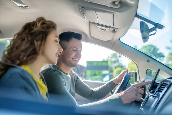 Young adult man and woman in a car.