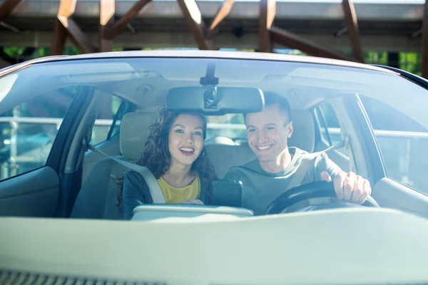 Mulher alegre e homem sentado em um carro de passageiros — Fotografia de Stock