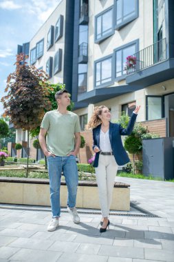 Daireyi arayan müşteriye olası değişkenleri gösteren zarif bir emlakçı.