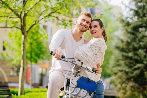 Satisfied young man and woman hugging dreamily looking — Stock Photo, Image