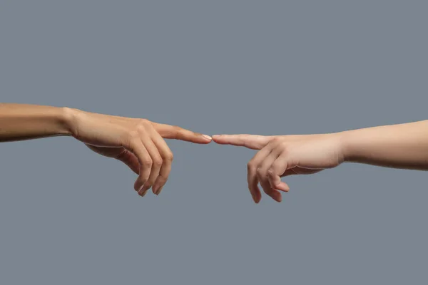 Close-up of people from different races touching two index fingers together — Stock Photo, Image