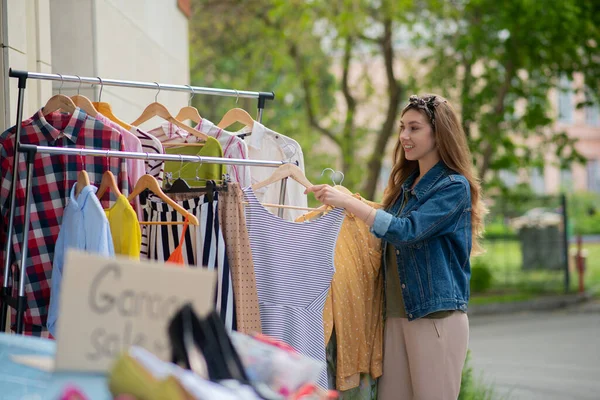 Pleasant good looking woman searching for a new dress — Stock Photo, Image