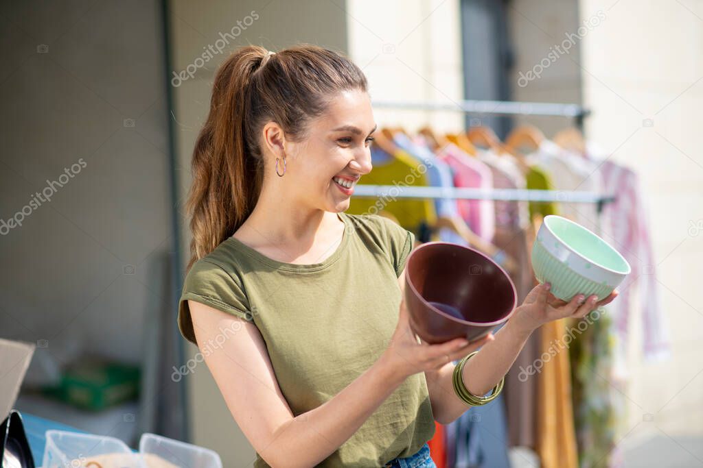Cheerful attractive woman wanting to buy a flower pot