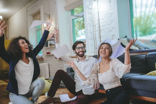 Happy boyfriend and two girlfriends rejoicing in overall success — Stock Photo, Image