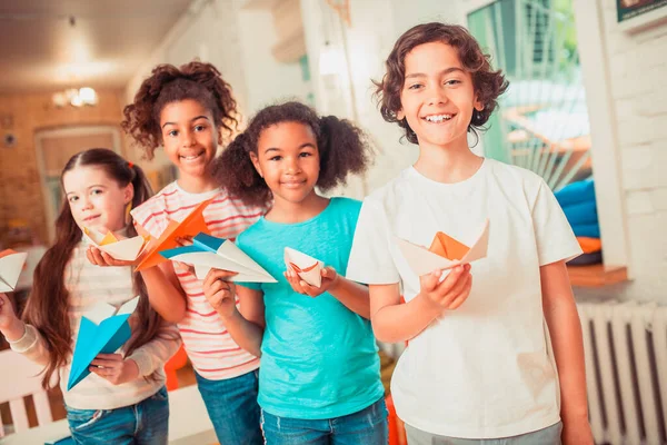 Happy kids holding their bright paper crafts — Stock fotografie