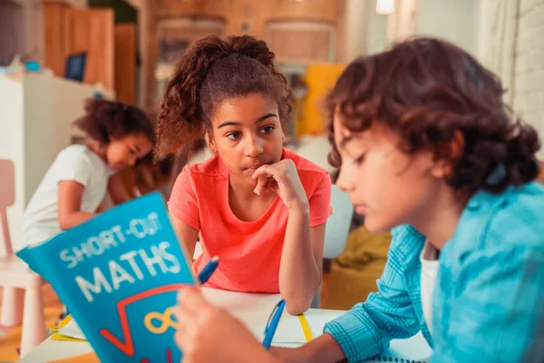 Thoughtful girl learning math with her classmate — Stock Photo, Image